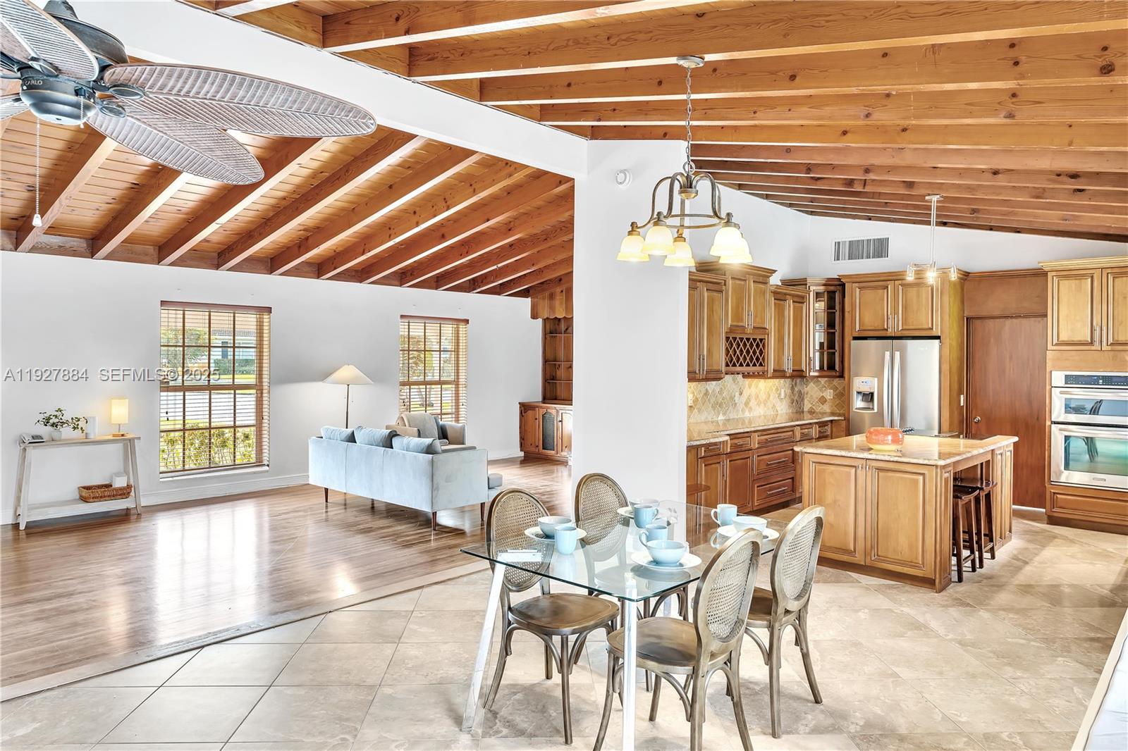 3437 Buchanan Street Hollywood, FL 33021 - Photo 14 of 40 a dining hall with stainless steel appliances a stove a dining table and chairs with wooden floor