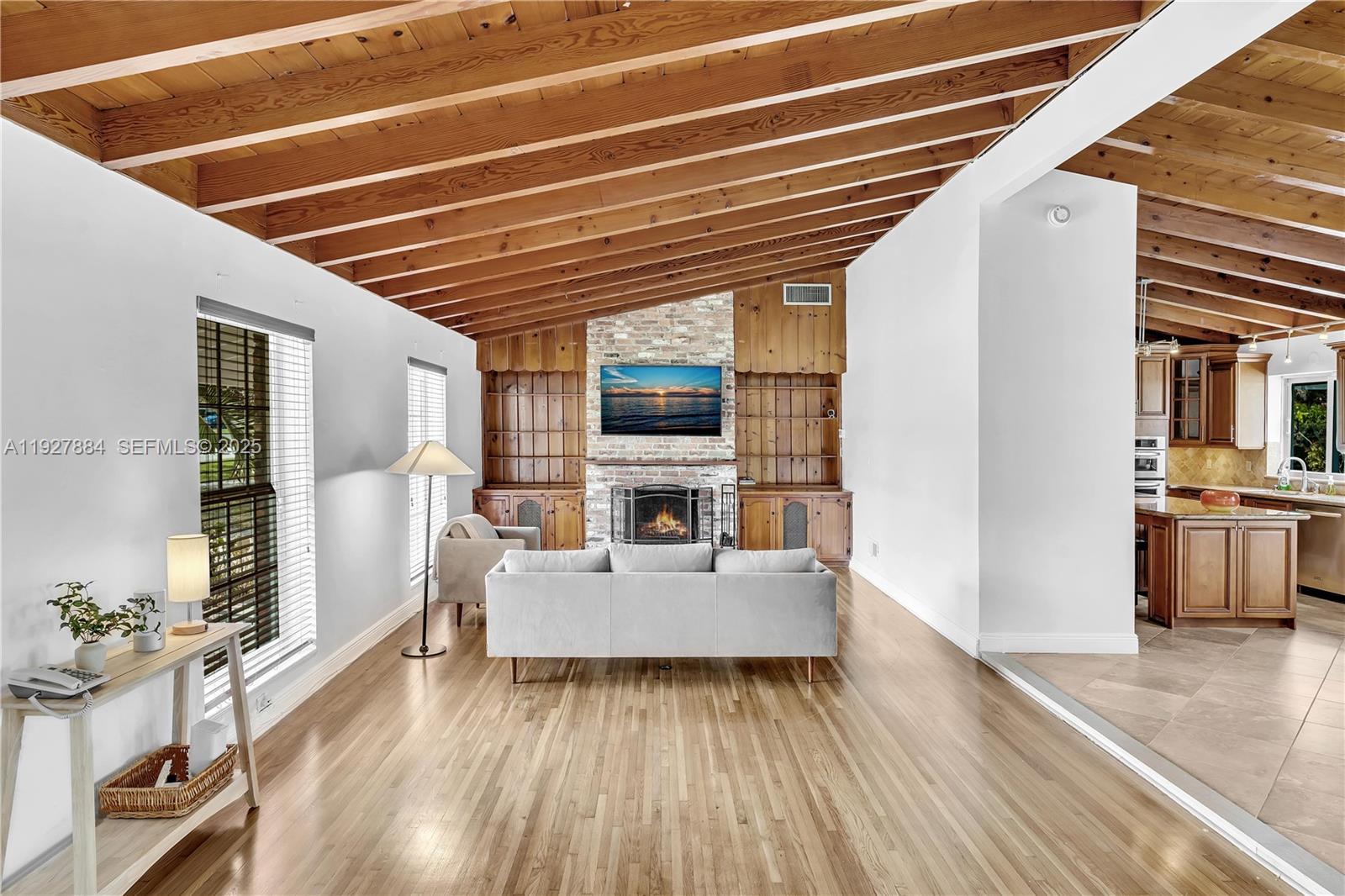 3437 Buchanan Street Hollywood, FL 33021 - Photo 2 of 40 a living room with furniture and a wooden floor