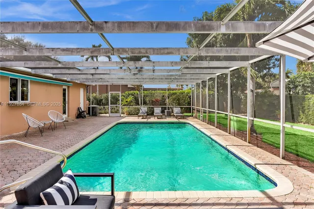 a backyard of a house with table and chairs