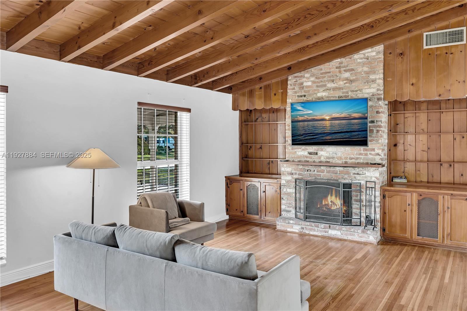 3437 Buchanan Street Hollywood, FL 33021 - Photo 3 of 40 a living room with furniture a flat screen tv and a fireplace