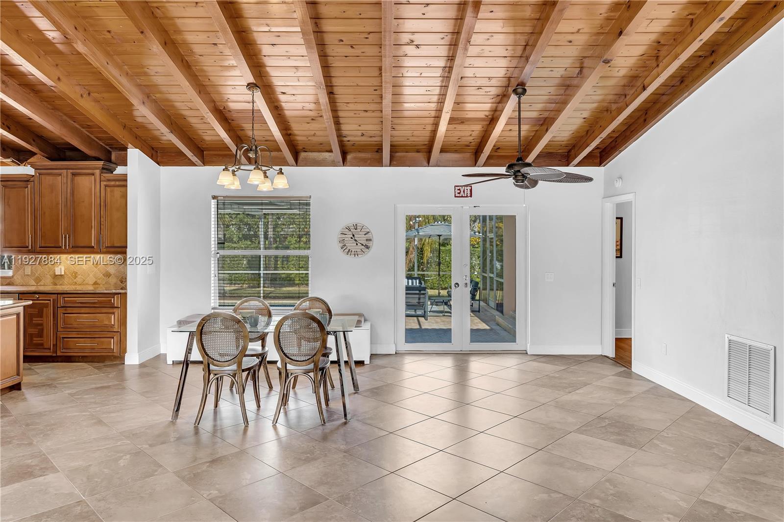 3437 Buchanan Street Hollywood, FL 33021 - Photo 5 of 40 a dining room with furniture and a floor to ceiling window