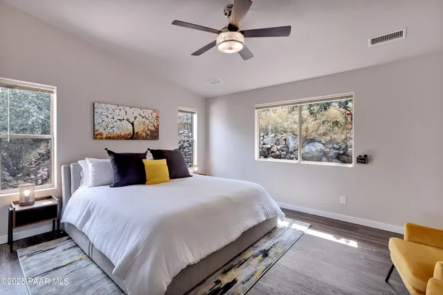 a bedroom with a bed and a painting on the wall