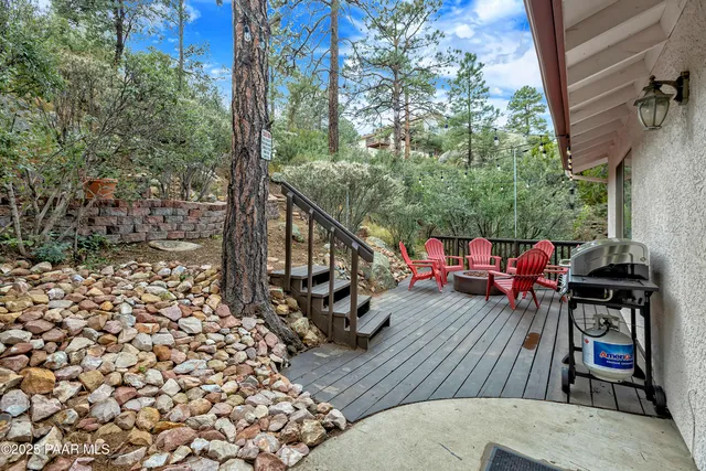 a view of a balcony with chairs and wooden floor