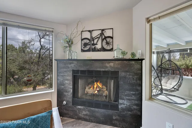 a living room with a fireplace and a floor to ceiling window