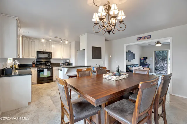 a view of a dining room and kitchen with a table & chairs