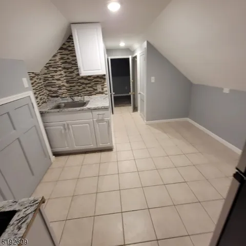 a view of a refrigerator and window in a kitchen