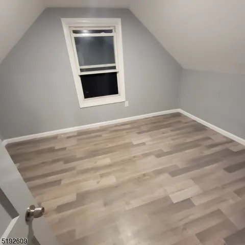 a view of an empty room with a fireplace and a chandelier
