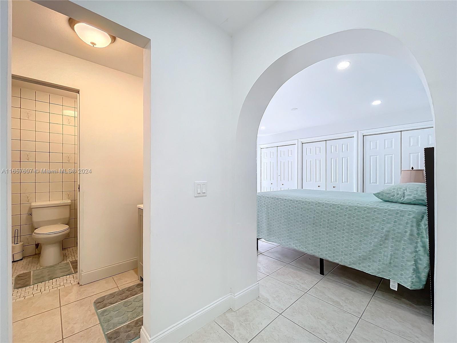 8218 Southampton Drive Miramar, FL 33025 - Photo 15 of 28 a en suite bathroom with a granite countertop sink and a mirror