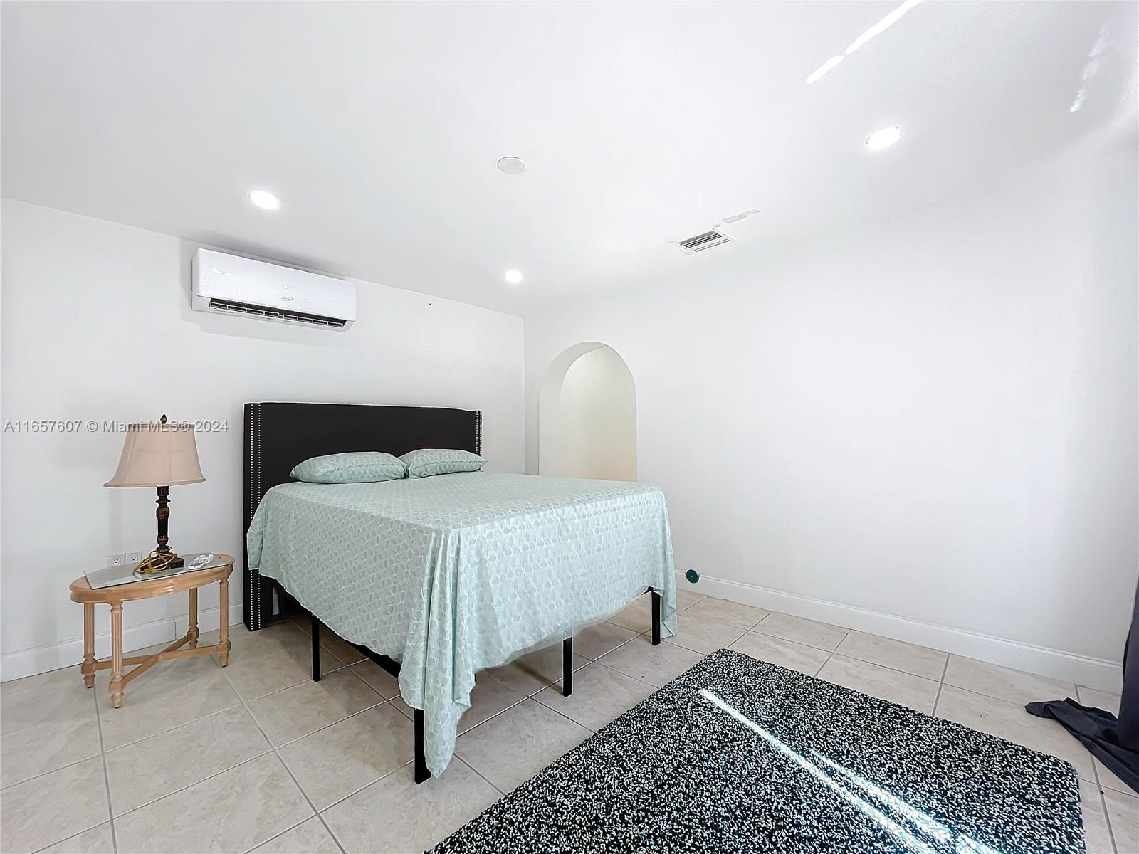 8218 Southampton Drive Miramar, FL 33025 - Photo 16 of 28 a bedroom with a bed and a lamp