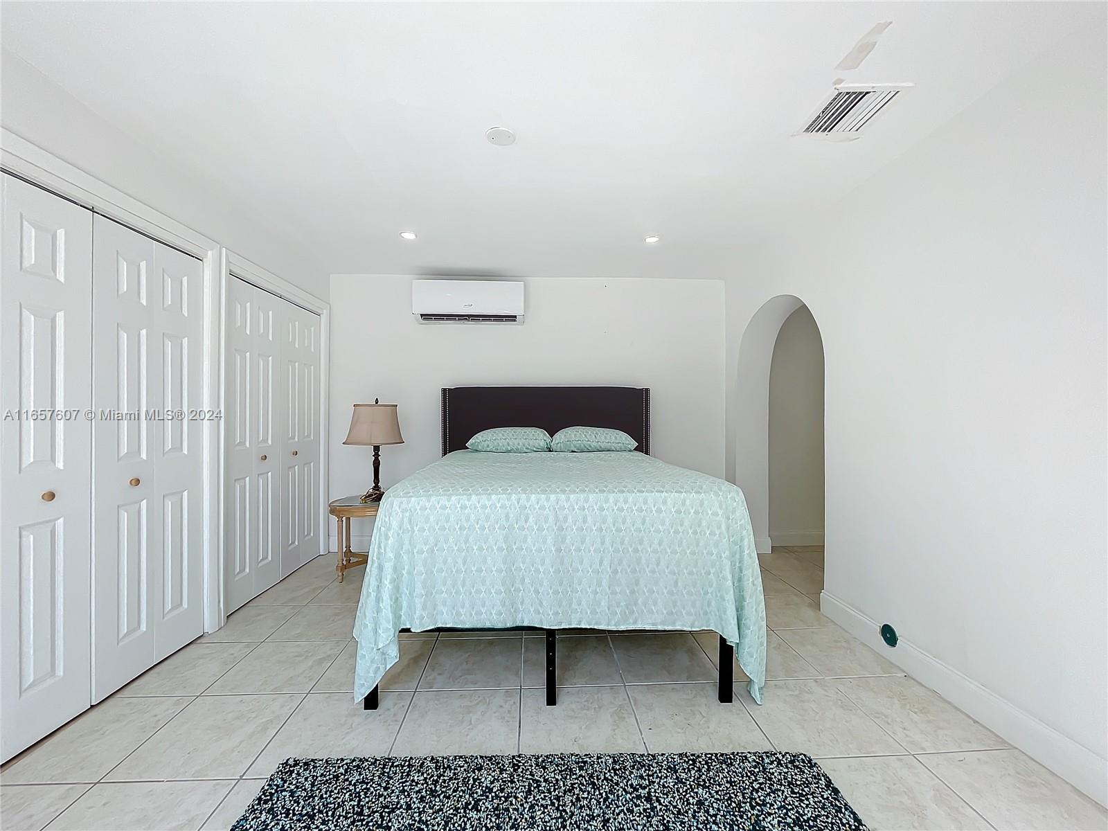 8218 Southampton Drive Miramar, FL 33025 - Photo 17 of 28 a bedroom with a bed and a table