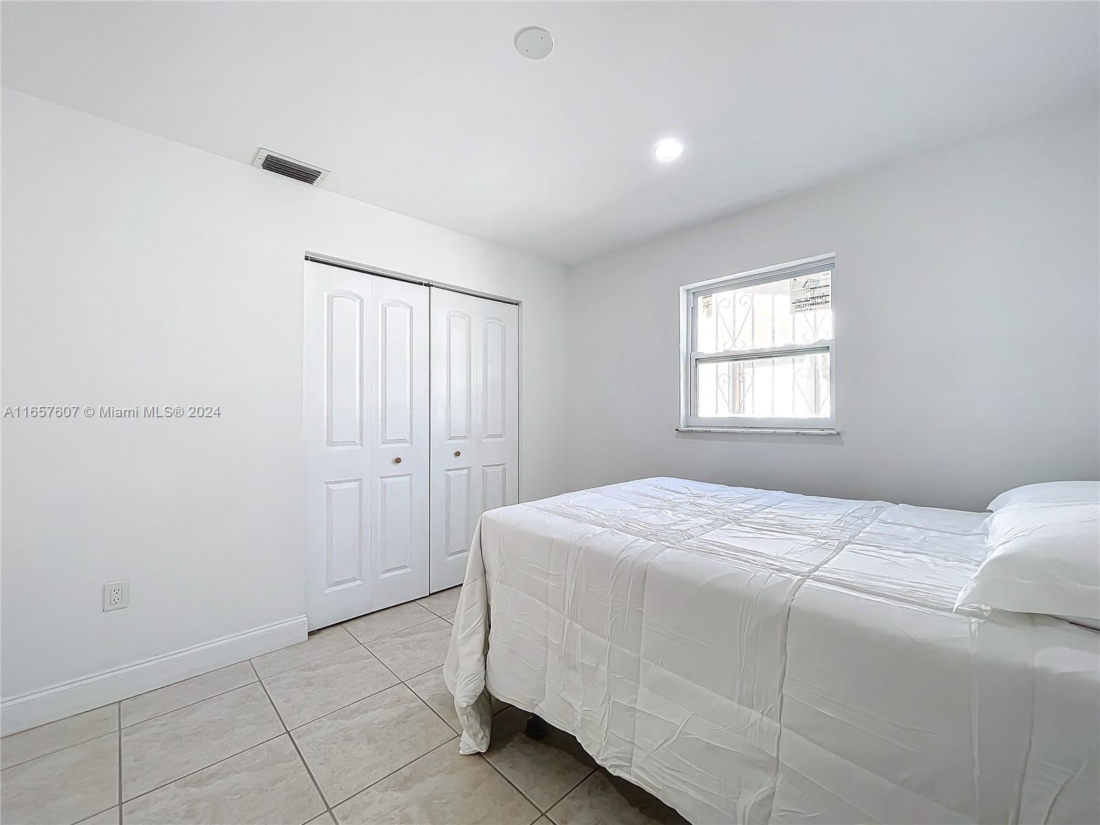 8218 Southampton Drive Miramar, FL 33025 - Photo 20 of 28 a bedroom with a bed and a window