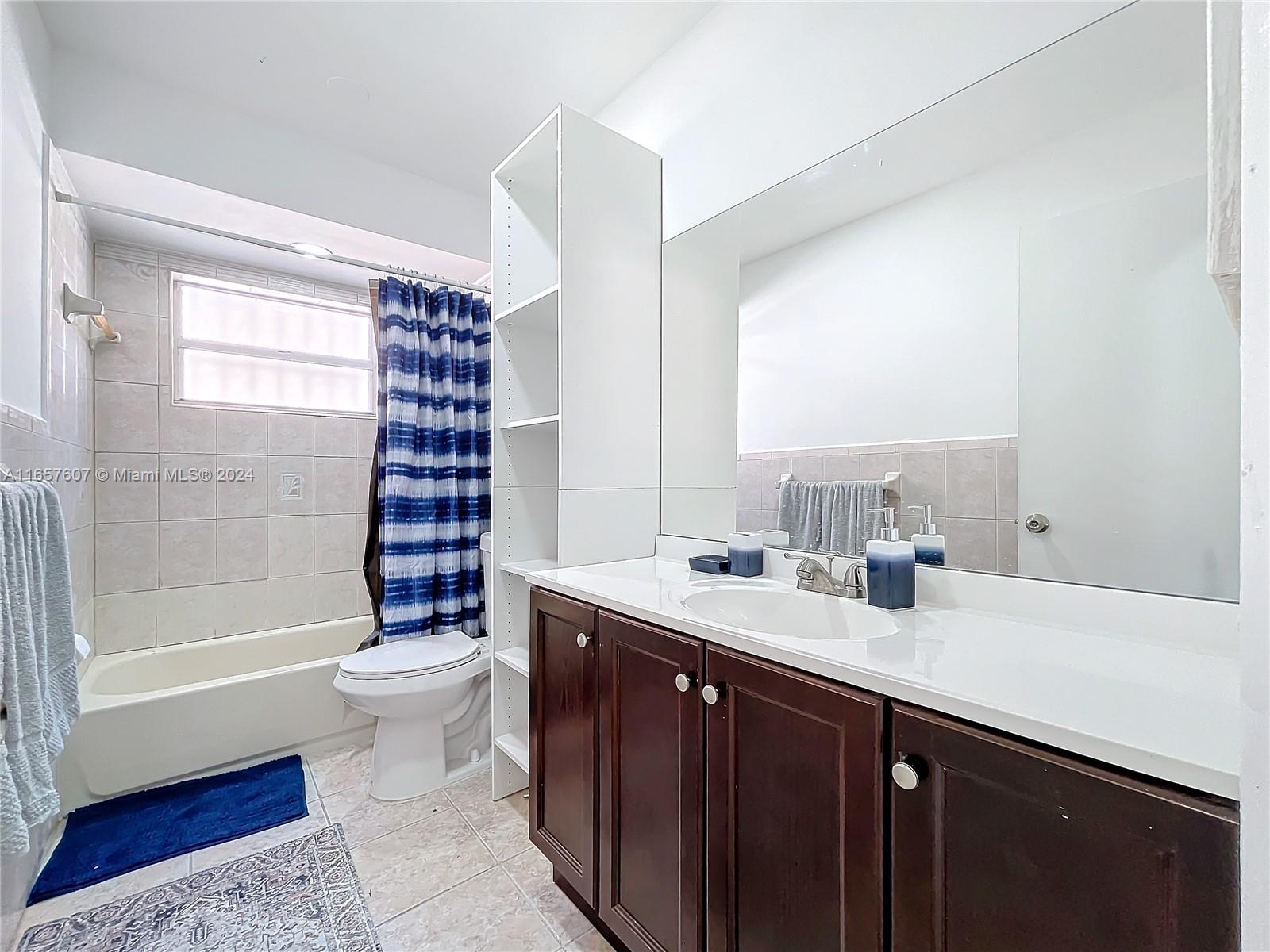 8218 Southampton Drive Miramar, FL 33025 - Photo 23 of 28 a bathroom with a double vanity sink toilet and shower