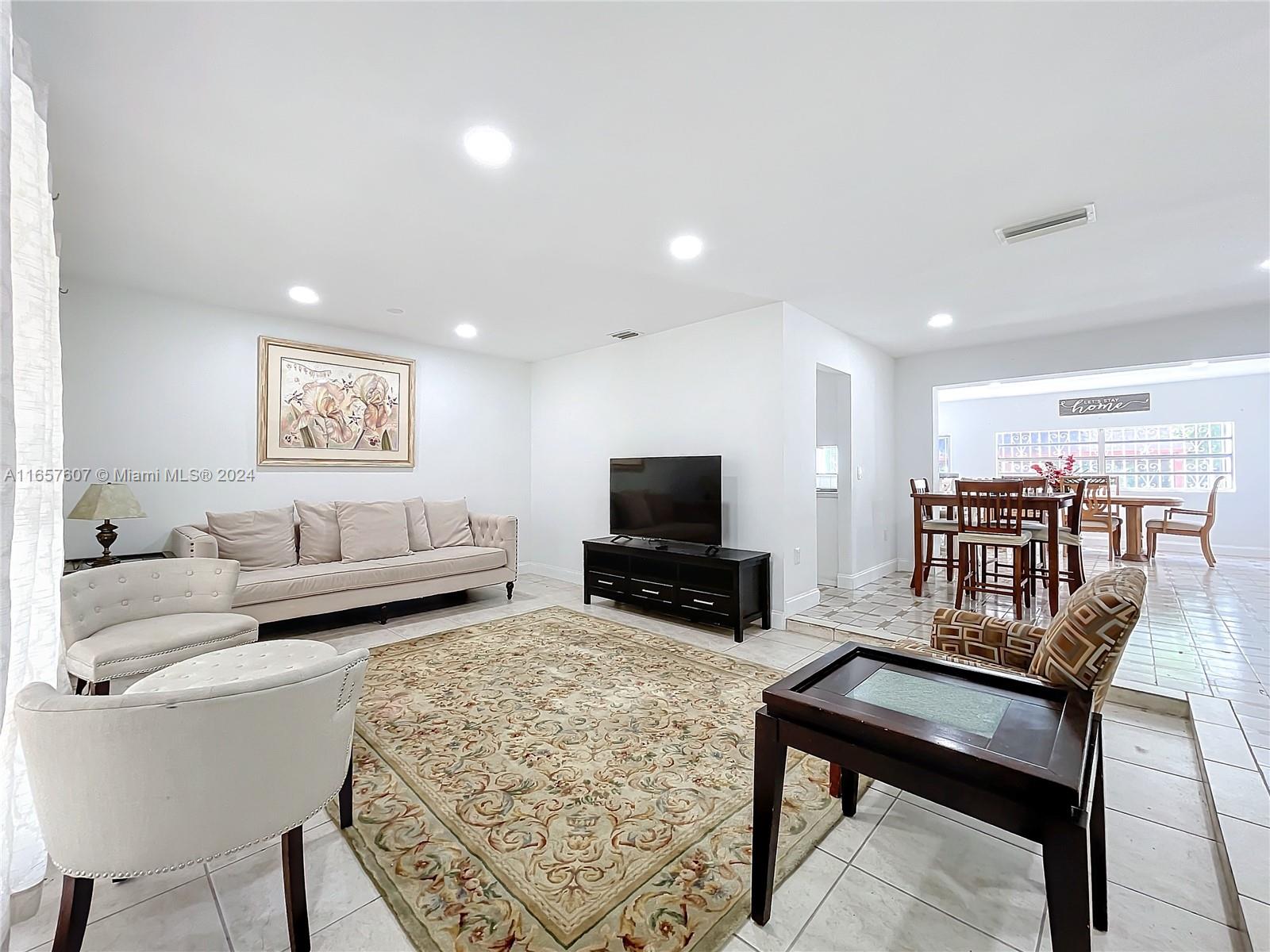 8218 Southampton Drive Miramar, FL 33025 - Photo 4 of 28 a living room with furniture and a flat screen tv