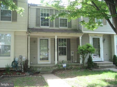 7811 Paddock Way Baltimore, MD 21244 - Photo 1 of 15 a front view of a house with garden