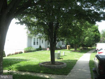 7811 Paddock Way Baltimore, MD 21244 - Photo 2 of 15 a garden with trees in front of it