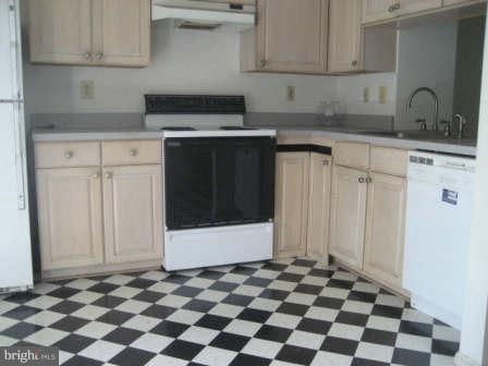 7811 Paddock Way Baltimore, MD 21244 - Photo 7 of 15 a kitchen with a stove a sink and cabinets