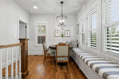 a spacious bedroom with a bed a couch and a chandelier