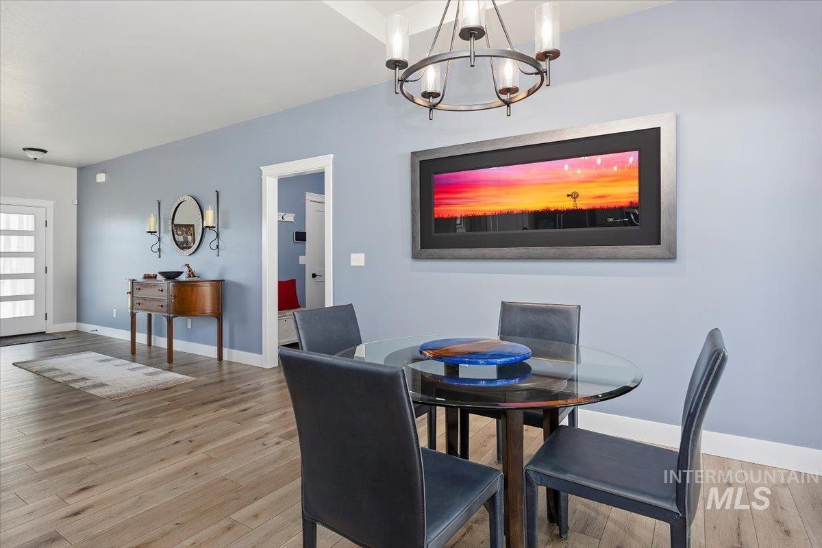 1436 Jump Street Twin Falls, ID 83301 - Photo 13 of 35 Dining area with light wood-style flooring and a chandelier