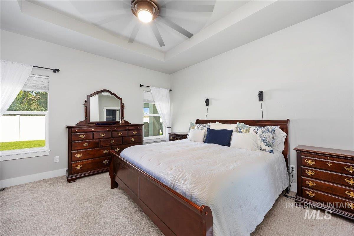 1436 Jump Street Twin Falls, ID 83301 - Photo 15 of 35 Bedroom featuring a tray ceiling, carpet, and ceiling fan