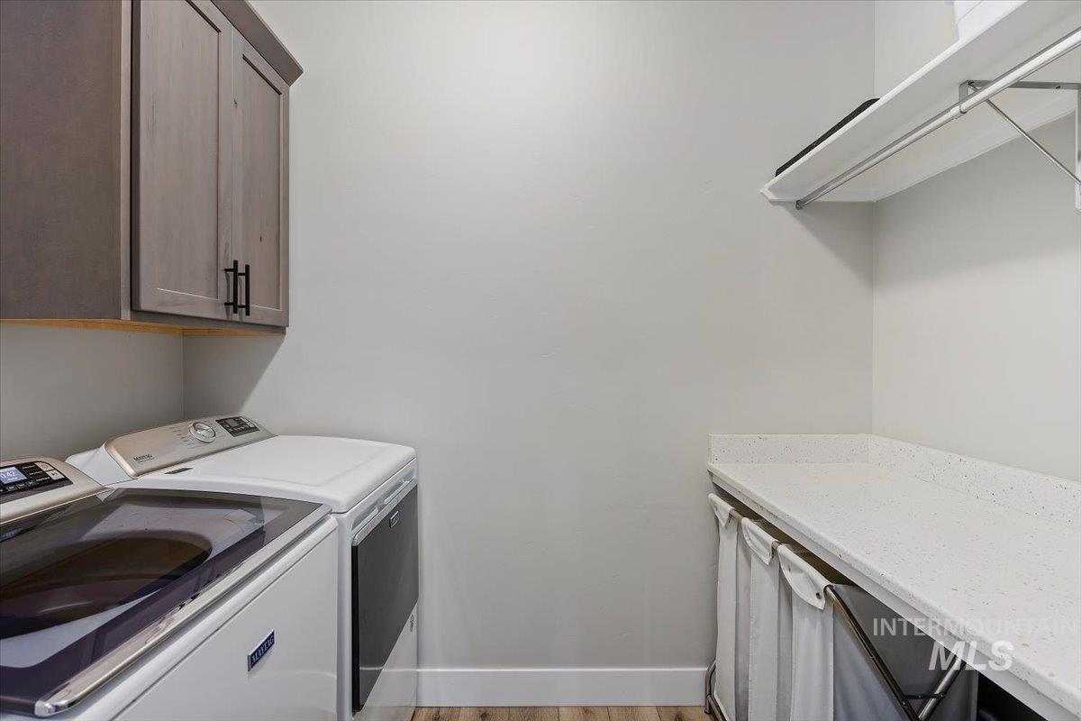 1436 Jump Street Twin Falls, ID 83301 - Photo 25 of 35 Washroom with cabinet space, washer and dryer, and light wood-type flooring
