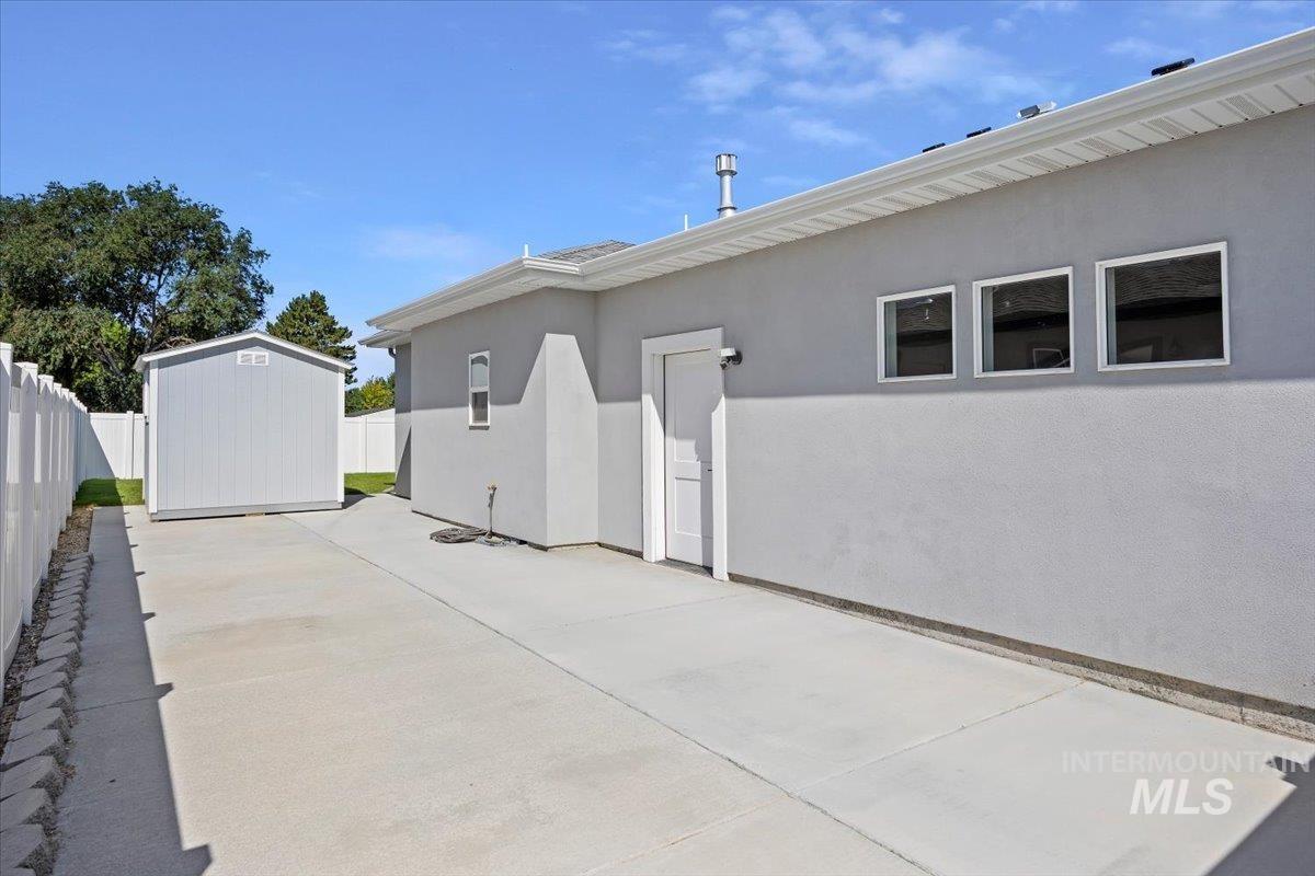 1436 Jump Street Twin Falls, ID 83301 - Photo 33 of 35 View of side of home featuring stucco siding, a storage shed, and a patio
