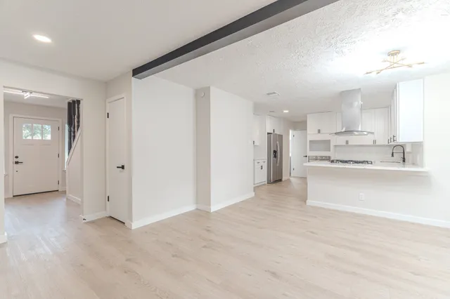 a view of a hallway with closet and entryway