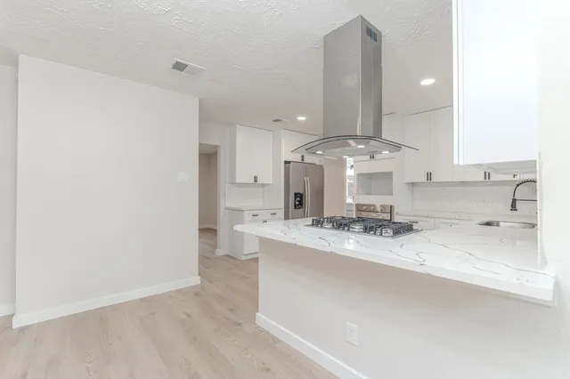 a bathroom with a double vanity sink mirror and shower