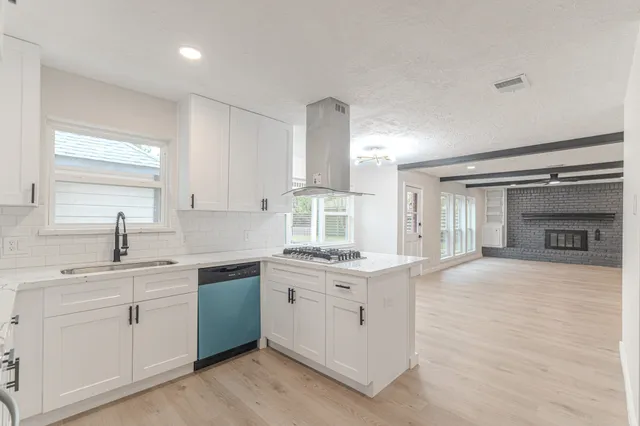 a bathroom with a shower a toilet and a window