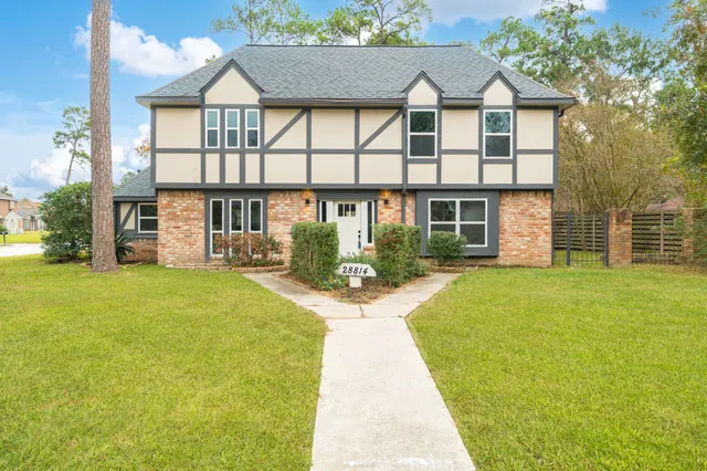 a view of a house with a yard and tree s