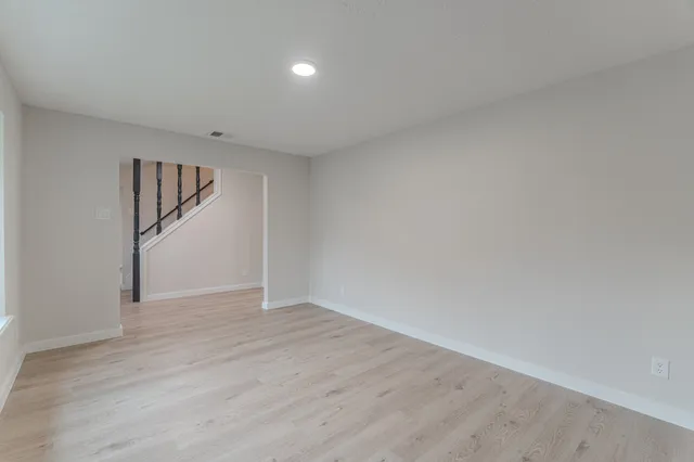 a view of empty room with a fireplace