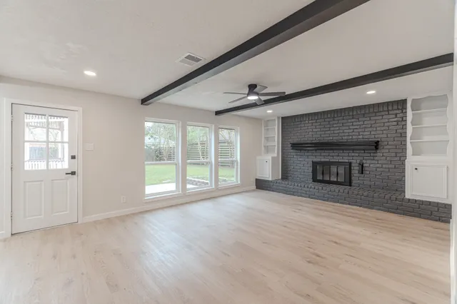 a kitchen with white cabinets appliances and a sink