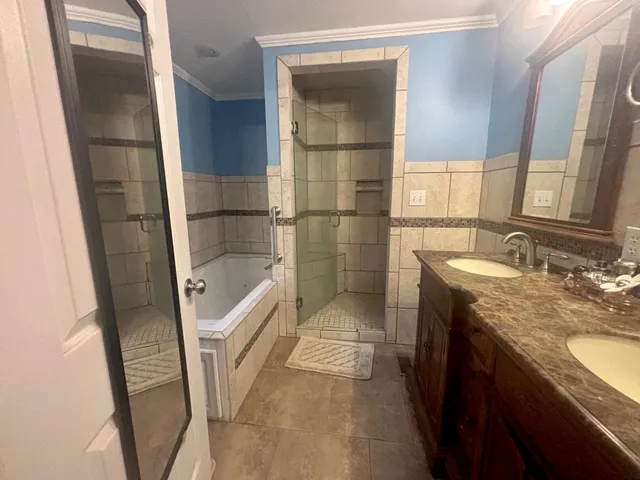 a bathroom with a double vanity sink and a mirror