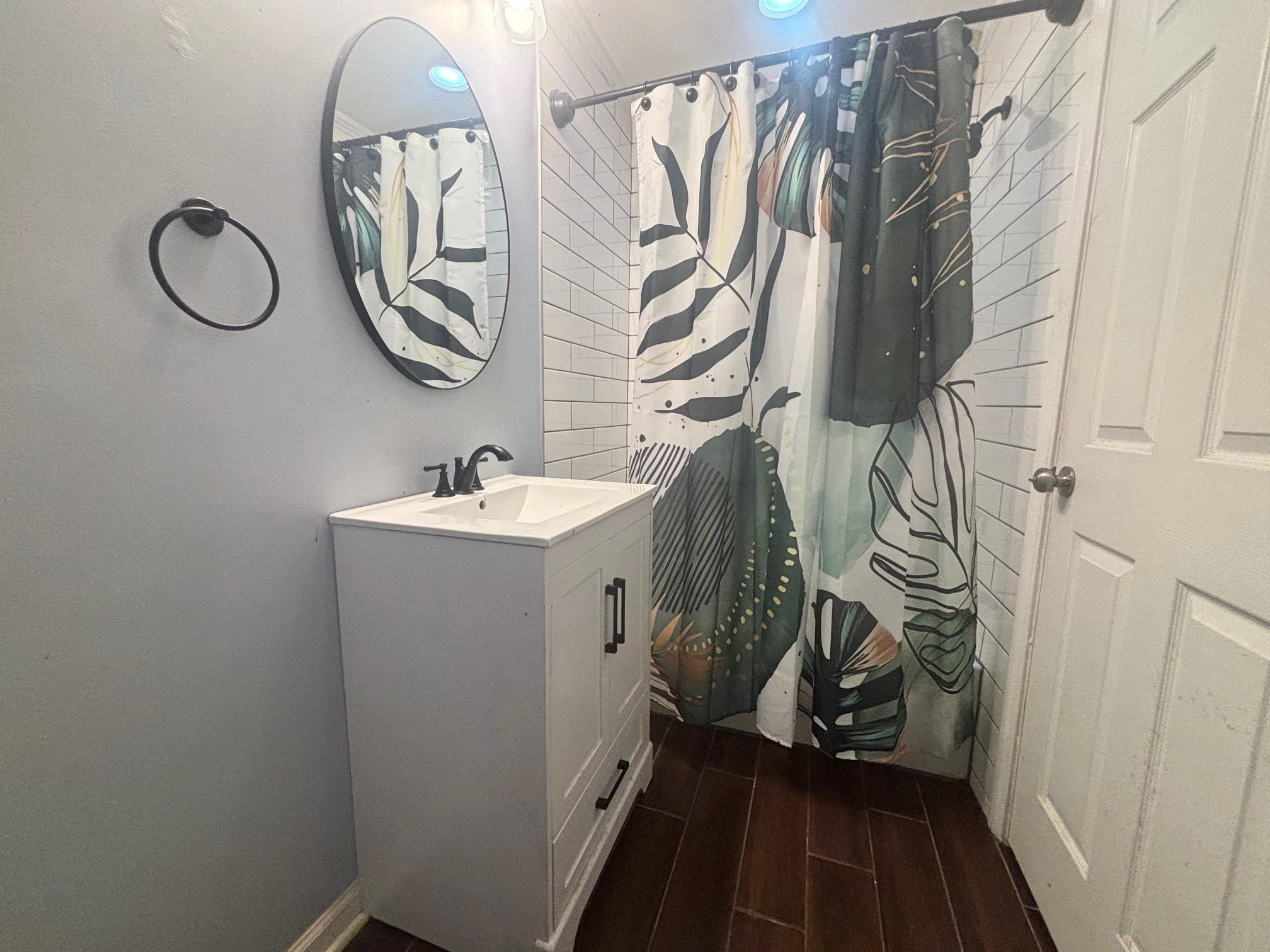 2 Cr 198 Road Iuka, MS 38852 - Photo 21 of 24 Full bathroom featuring curtained shower, vanity, and wood finish floors