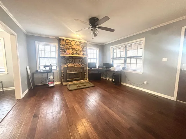a spacious bedroom with a bed and a chandelier