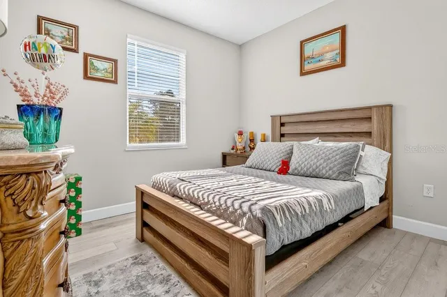 a bed sitting in a bedroom next to a window