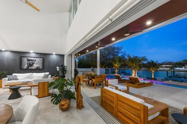 a large white kitchen with a stove a sink a dining table and chairs