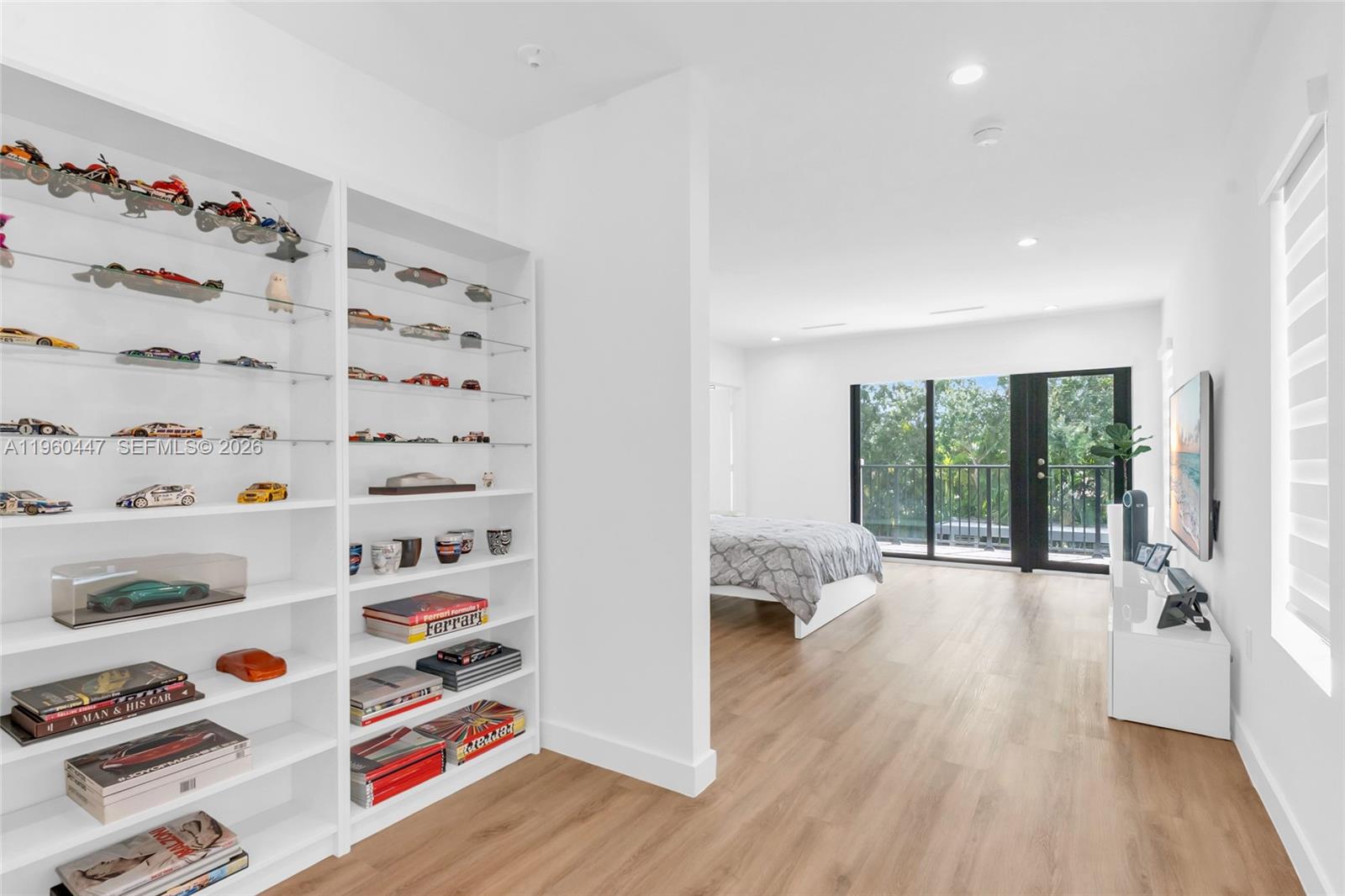 2029 Southwest 62nd Avenue Miami, FL 33155 - Photo 25 of 43 a view of workspace with wooden floor and book shelf