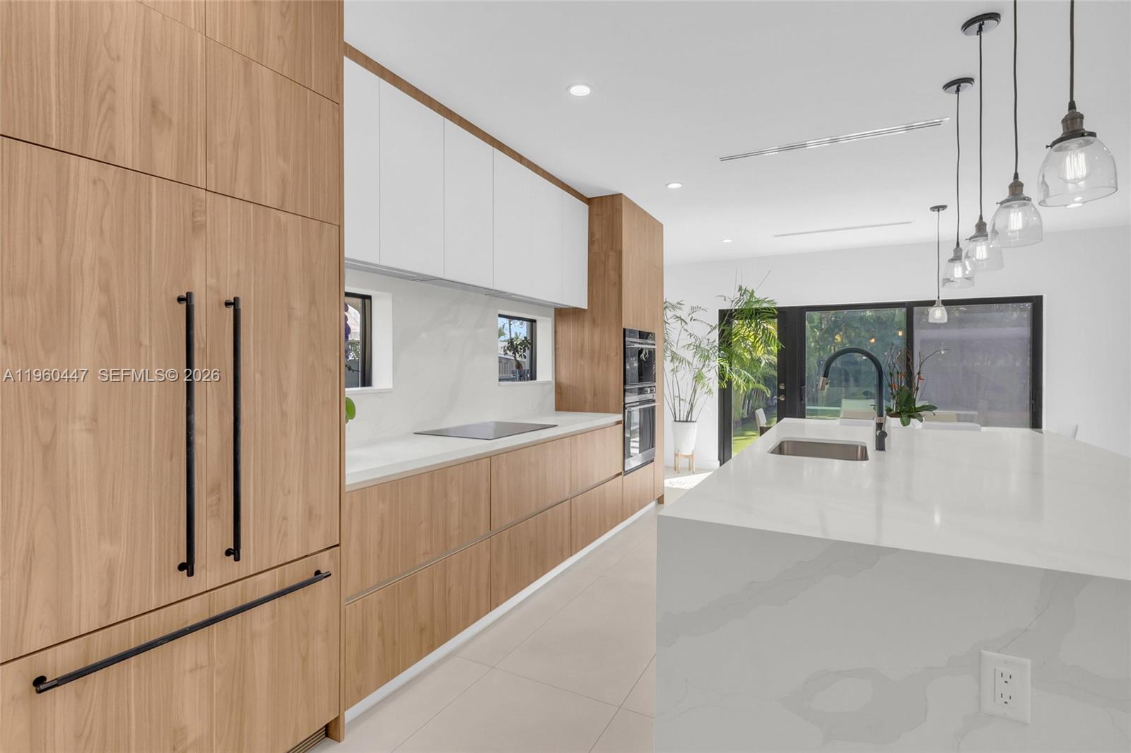 2029 Southwest 62nd Avenue Miami, FL 33155 - Photo 8 of 43 a large white kitchen with cabinets a sink and a refrigerator