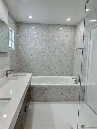 a bathroom with a bathtub and a sink