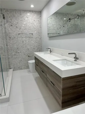 a bathroom with a sink a toilet and mirror