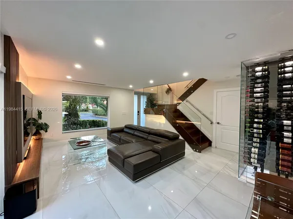 a living room with furniture a couch and potted plants