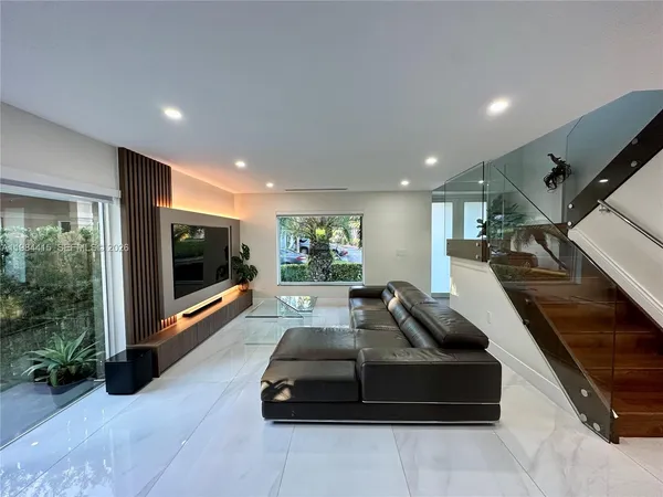 a living room with furniture gym equipment and a large window