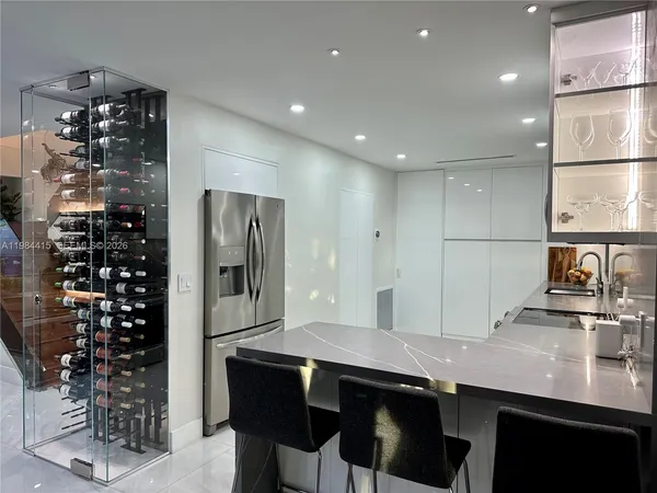 a kitchen with stainless steel appliances a sink and a refrigerator