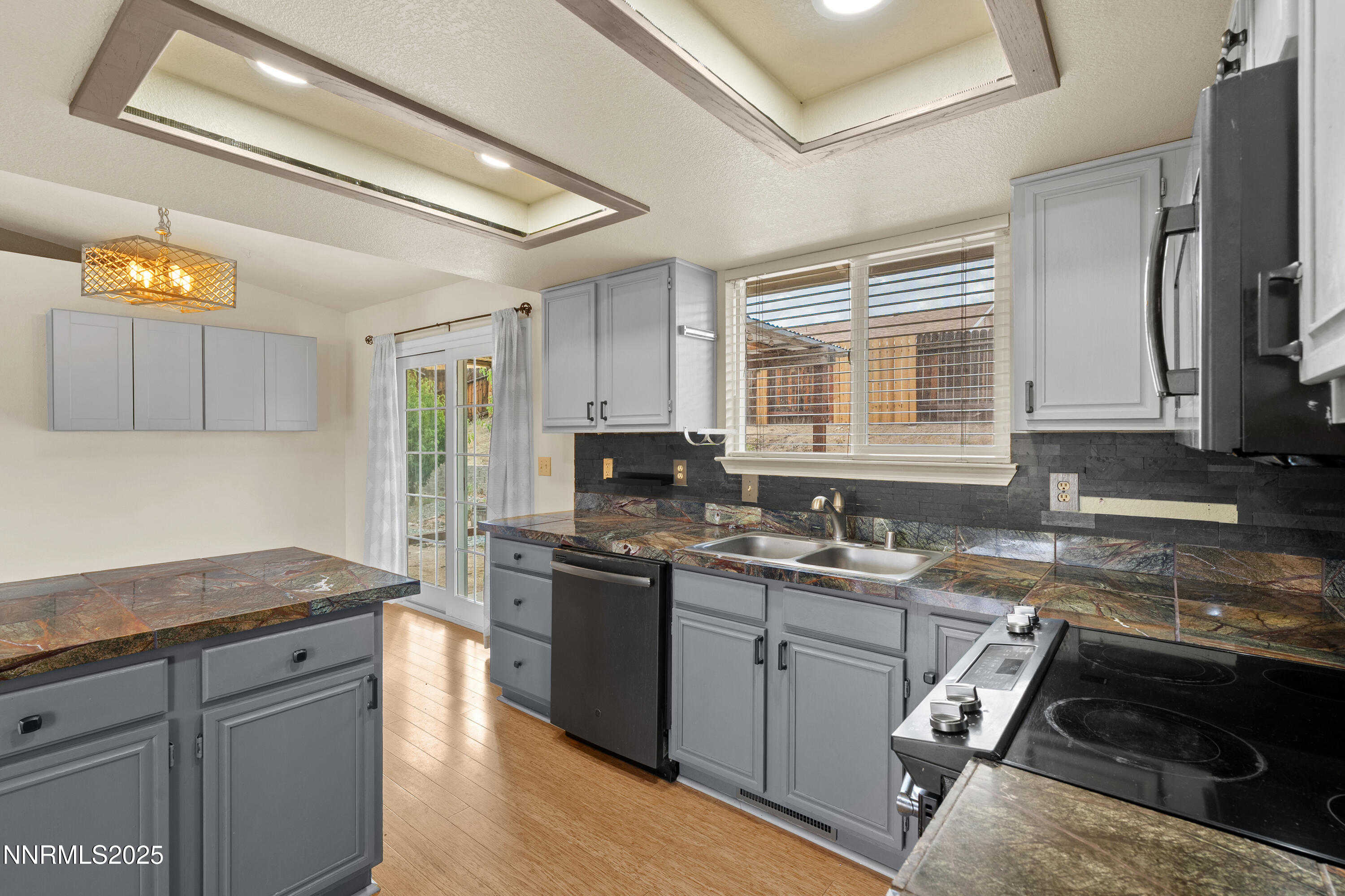 997 Ridgeview Drive Carson City, NV 89705 - Photo 13 of 32 a kitchen with stainless steel appliances granite countertop a sink stove and refrigerator