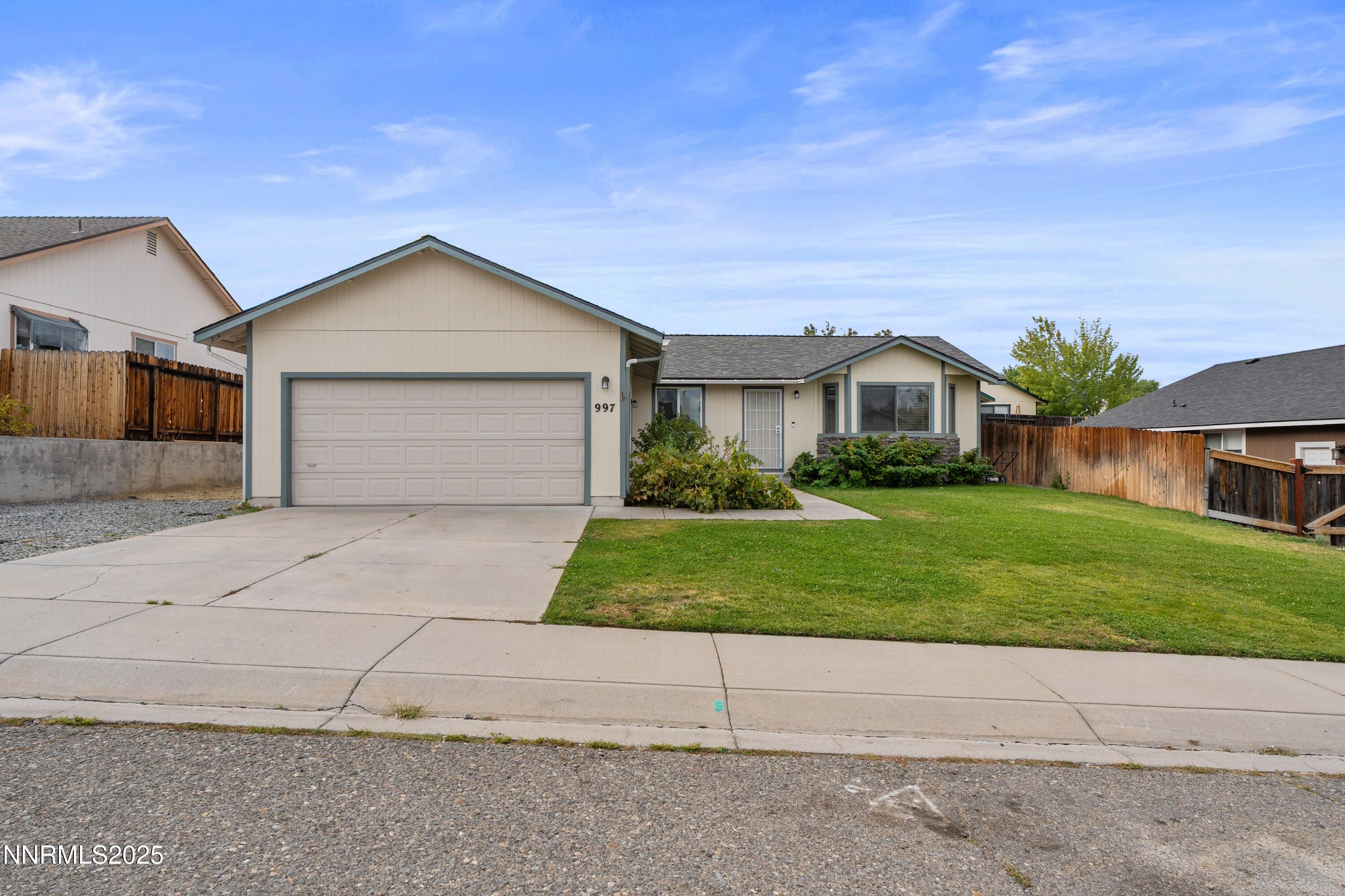 997 Ridgeview Drive Carson City, NV 89705 - Photo 2 of 32 a front view of a house with a yard and garage