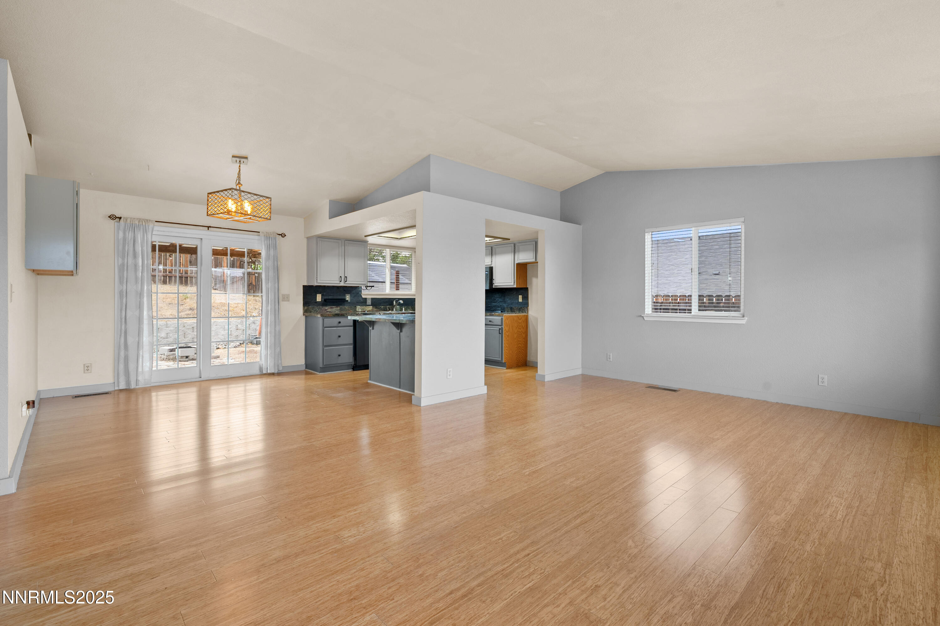 997 Ridgeview Drive Carson City, NV 89705 - Photo 5 of 32 a view of an empty room with a window and a kitchen