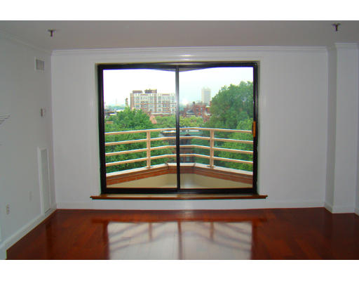 390 Commonwealth Avenue, Unit 710 Boston, MA 02215 - Photo 4 of 14 a view of empty room with wooden floor and windows