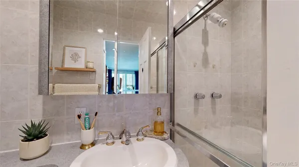 a bathroom with a tub sink and mirror