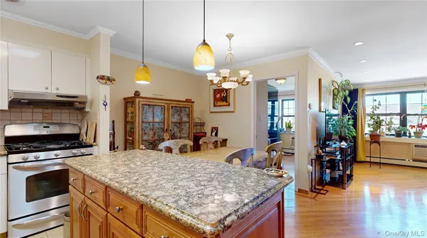 a kitchen with stainless steel appliances granite countertop a stove oven and a granite counter top