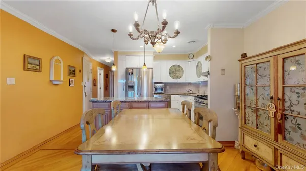a room with stainless steel appliances kitchen island granite countertop furniture and a flat screen tv